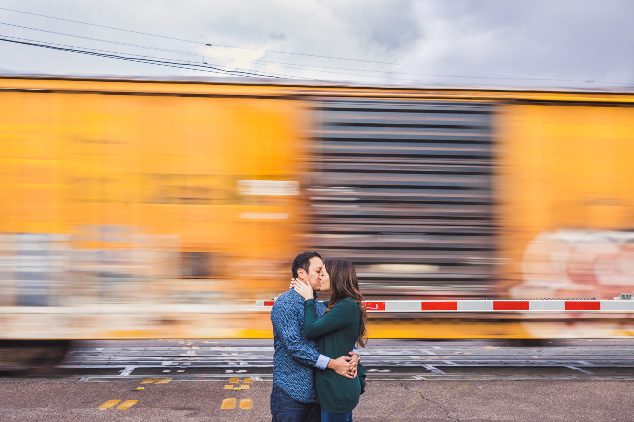 Location: Downtown Tucson, AZThis couple wanted a train track photo, but we knew we didn't want to make the same old train track photo that's been done a million times. I came up with the idea to use a moving train and I love how it turned out. I lo…