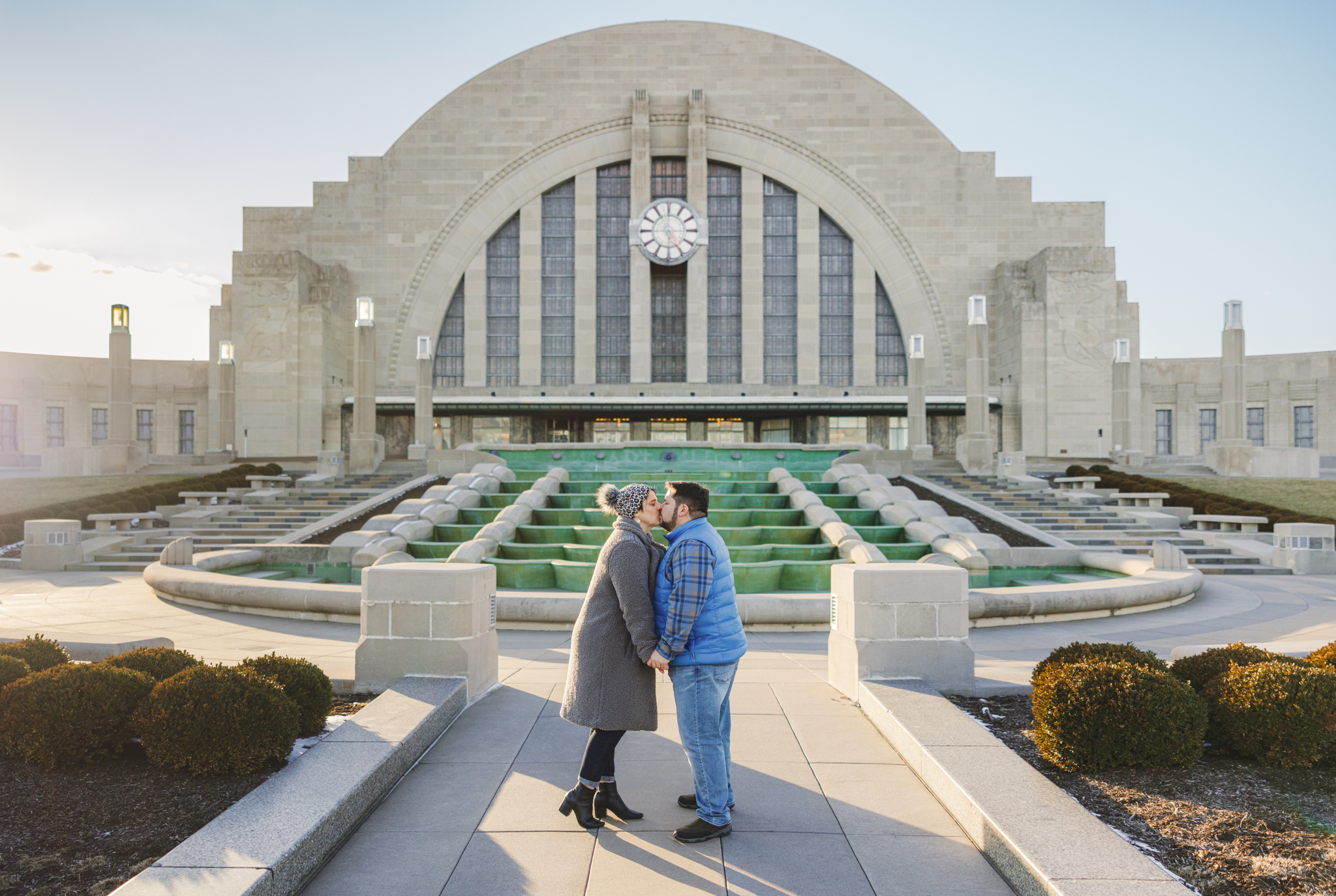 Engaged couple kissing in front of Union Terminal in Cincinnati